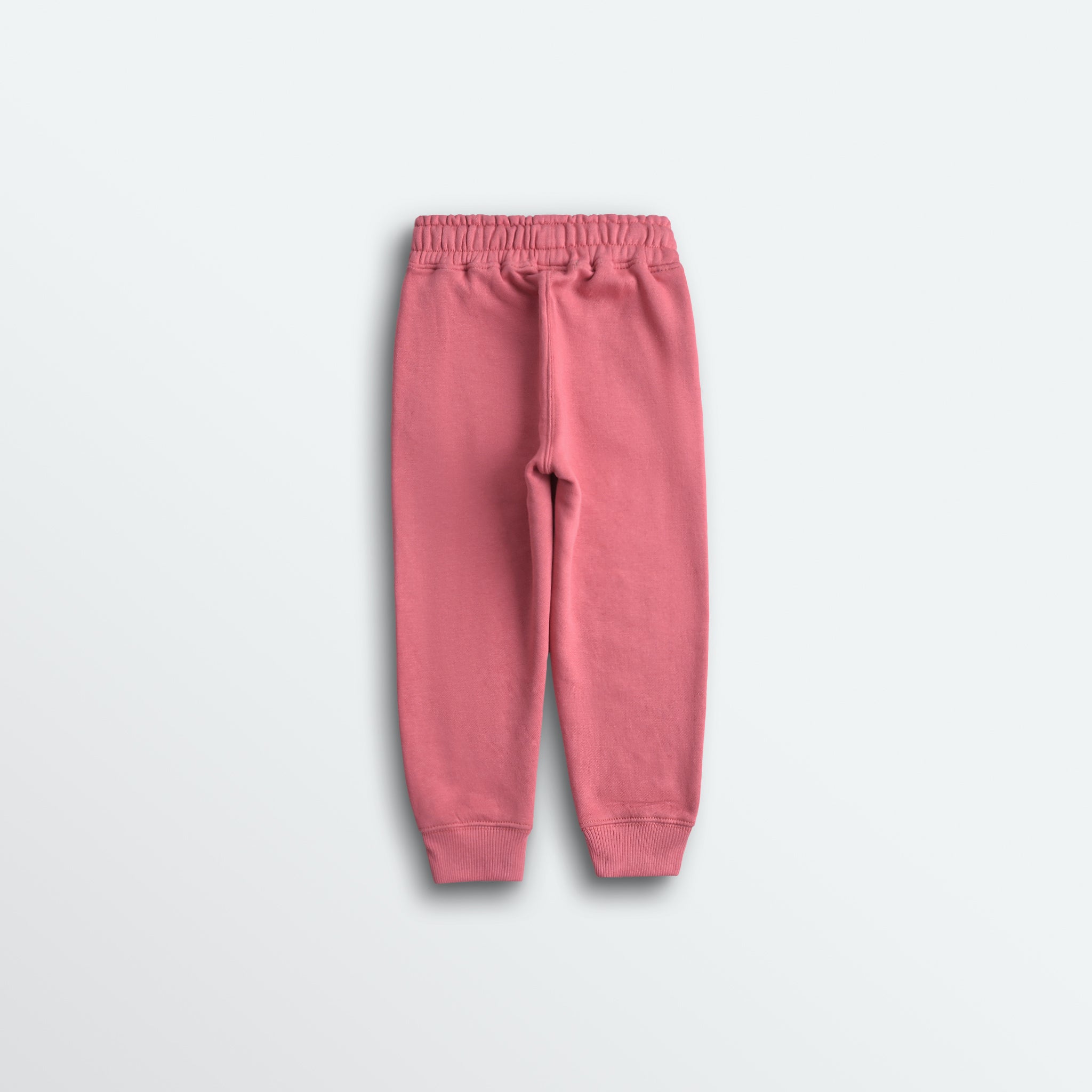 Pink sweatpants on a light gray background